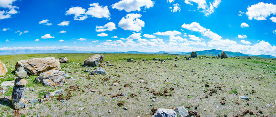 Tarkhatinsky megalithic complex. Steppe and blue mountains on the horizon. Altai Russia
