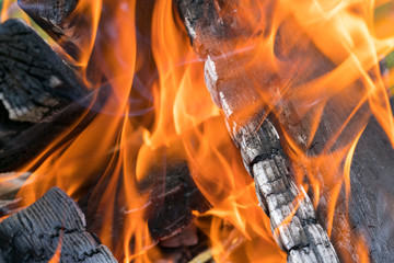 Fireplace burning. Warm cozy burning fire in a brick fireplace close up. Cozy background. Close up shot of burning firewood in the fireplace