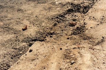 Part of the road under construction with tire tracks