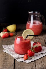 Glass of Tasty Strawberry Peach Smoothie with Lemon on Linen Napkin Wooden Background Fresh Strewberry Peach and Lemon Heathy Diet Drink Refreshing Summer Drink