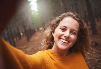 Self portrait of playful smiling young woman