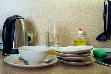 Dirty plates, cups and glasses on the kitchen table