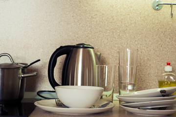 Dirty plates, cups and glasses on the kitchen table