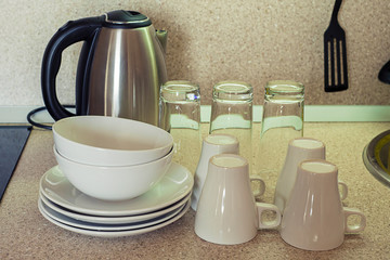 Clean plates,cups and glasses on the kitchen table