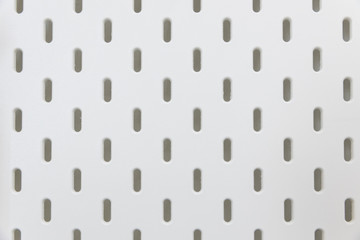 empty white pegboard or holes wall for hanging tool texture background.