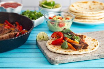 Beef Fajitas with Bell Peppers on a Blue Wood Table