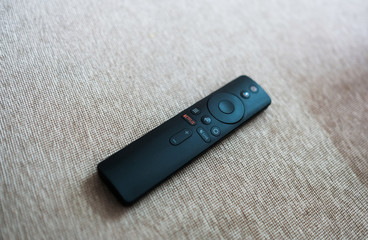 Watching tv and using remote control  to change the channel 