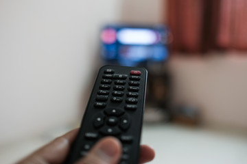 Watching tv and using remote control  to change the channel 