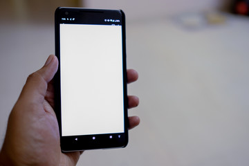 Man hand holding the black smartphone with blank screen and modern small frame design - isolated focus 