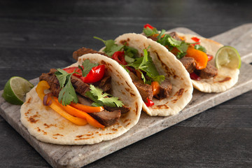 Beef Fajitas with Bell Peppers on a Wooden Table