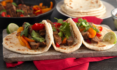 Beef Fajitas with Bell Peppers on a Wooden Table