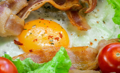 Sunny Side Up Eggs with crispy fried bacon, arugula and tomatoes