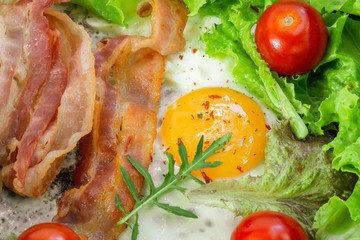 fried eggs for Breakfast close-up with bacon
