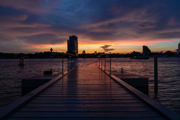 Boat Dock on river with Beautiful Sunset Twilight Time Background. Landscape Concept.