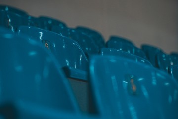 Stadium Seats. Sport arena blue and yellow plastic seats. Indoor.