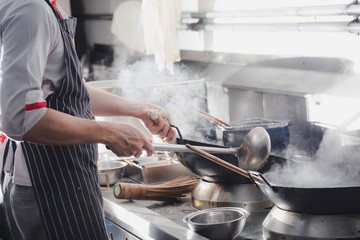 Chef stir fry in wok