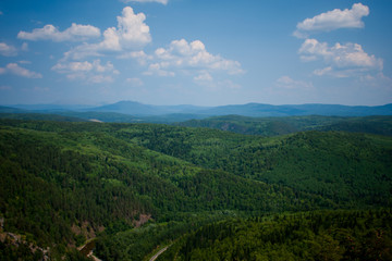 Fototapeta na wymiar view of the Ural mountains in sunny weather from the mountain