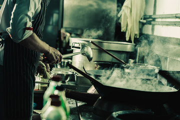 Chef stir fry in wok