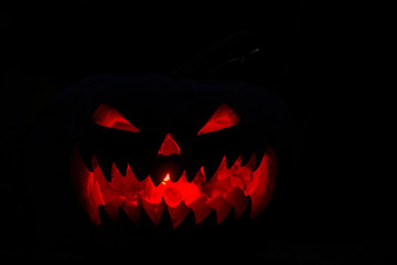 Naklejka premium scary pumpkin for Halloween on a black background