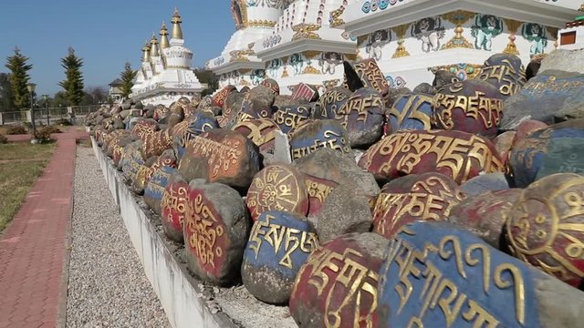 Pray stones in front of Buddhism monastery in Indian Tibet colony 
