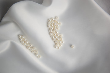 Ivory beads on white wedding fabric