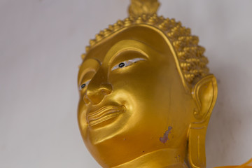 Buddha statue, statue in the Buddhist temple, Phra Sok, Sri Ayuthaya, Thailand, isolated on white background (Focus on the face)