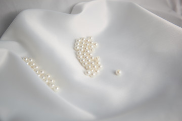 Ivory beads on white wedding fabric