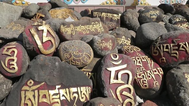 Pray stones in front of Buddhism monastery in Indian Tibet colony 