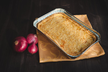  french onion cake on dark wooden background with red onions