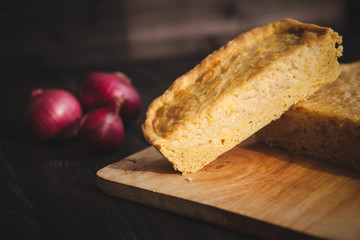  french onion cake on dark wooden background with red onions
