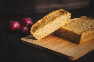  french onion cake on dark wooden background with red onions