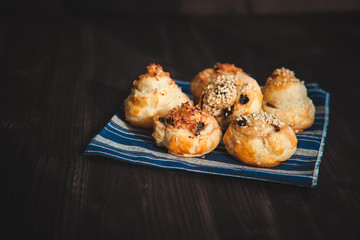  puff buns with raisins on a blue background