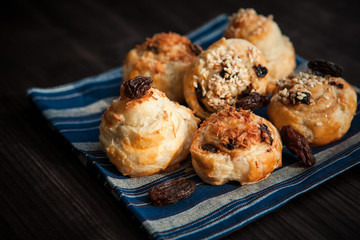  puff buns with raisins on a blue background