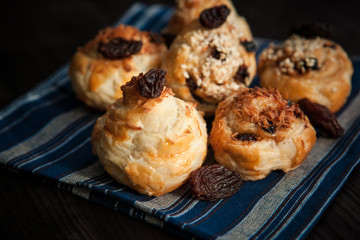  puff buns with raisins on a blue background