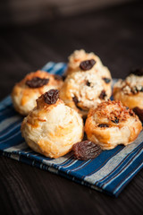  puff buns with raisins on a blue background