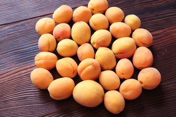 freshly picked orange apricots on a wooden background