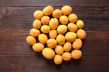 freshly picked orange apricots on a wooden background
