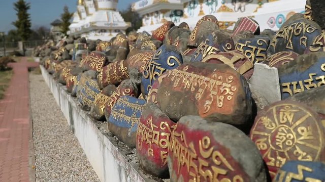 Pray stones in front of Buddhism monastery in Indian Tibet colony 