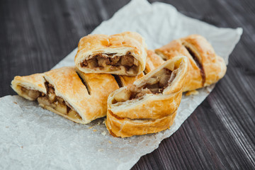 strudel with apple and cinnamon on a light towel, light background