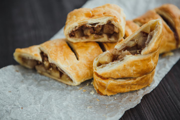 strudel with apple and cinnamon on a light towel, light background