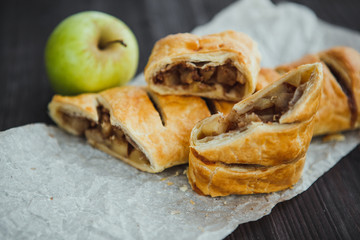 strudel with apple and cinnamon on a light towel, light background