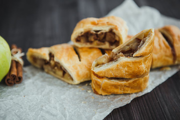 strudel with apple and cinnamon on a light towel, light background