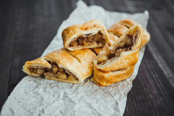 strudel with apple and cinnamon on a light towel, light background