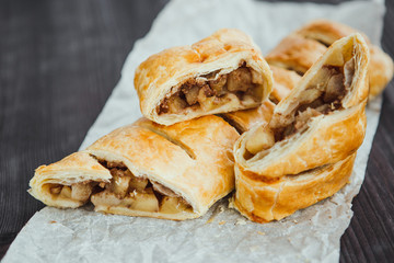 strudel with apple and cinnamon on a light towel, light background