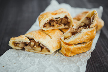 strudel with apple and cinnamon on a light towel, light background