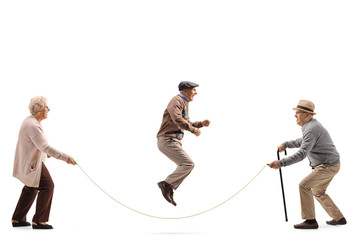 Senior people skipping a rope