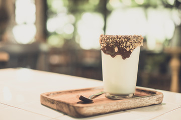Cappuccino with chocolate caramel in cafe, table cafe