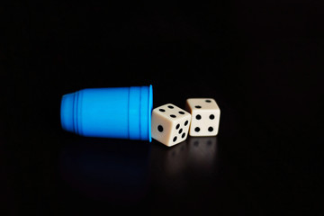 Two dice in a black background.