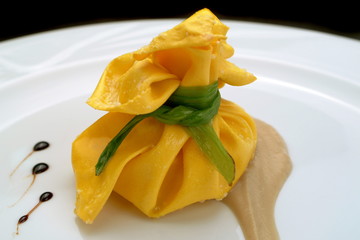 Italian food recipes, small bundle of pasta stuffed with zucchini and eggplants sauce.