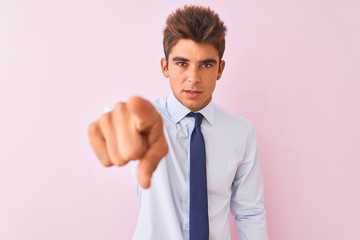 Young handsome businessman wearing shirt and tie standing over isolated pink background pointing displeased and frustrated to the camera, angry and furious with you